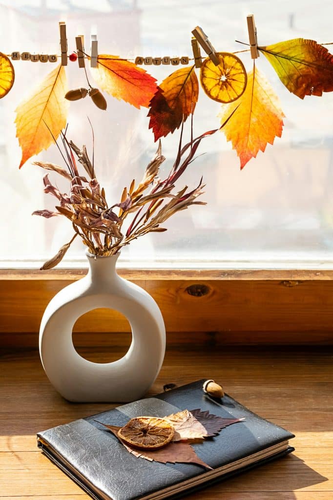 Autumn aesthetic still life on windowsill. Fall home decorating.