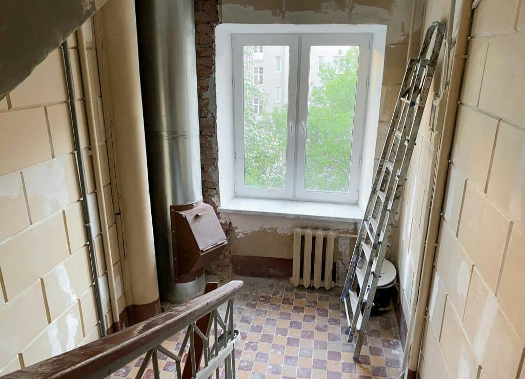 Repair works, renovation of the entrance of an apartment building. Stairwell, window, garbage chute