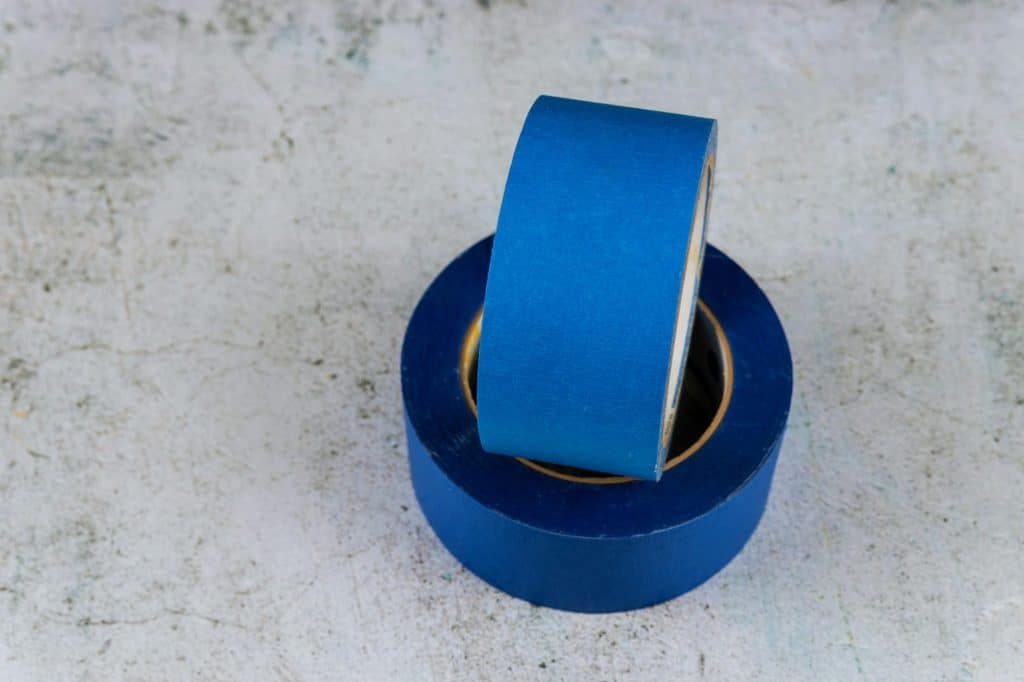 Set of blue painter plastic duct tape over the white background