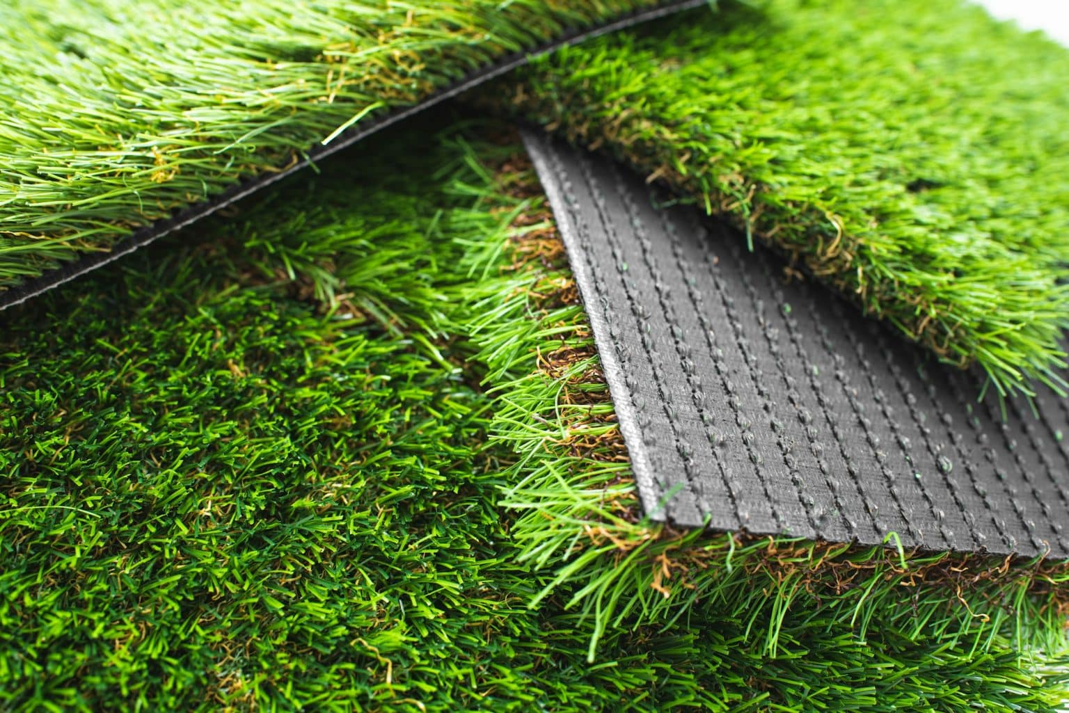 Detail of types of artificial grass in a sample book.